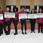 Group holding signs